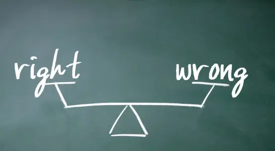 A drawing of a scale between right and wrong in a blackboard and chalk.
